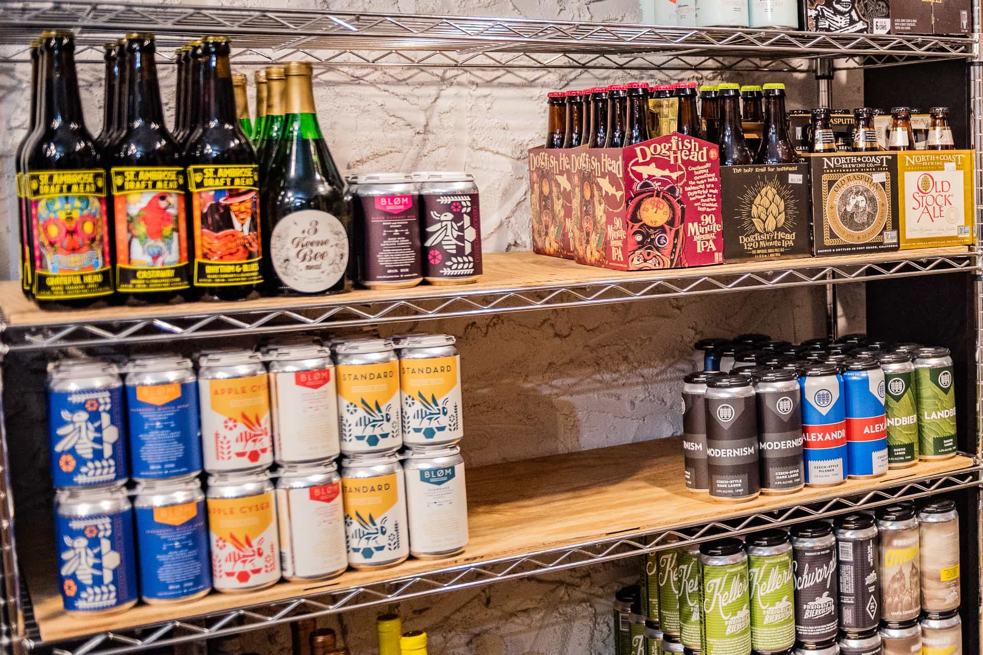 A display rack containing cans and bottles of beer.